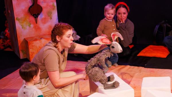 Children watching a show with puppets.