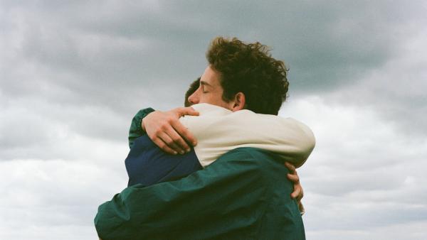 Two young people hugging