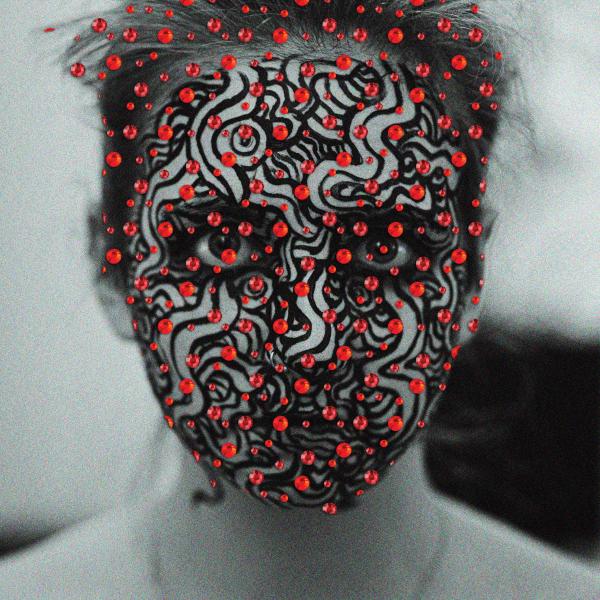 A black and white image of a woman staring into the camera, with black painted squiggles on her face and red gems layered over the image.