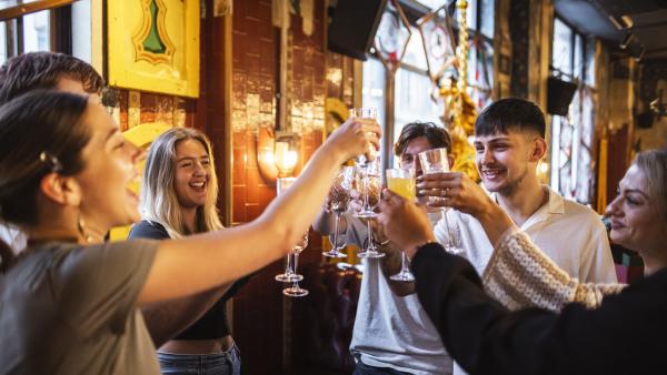 A group of people celebrating with Prosecco and Mimosas