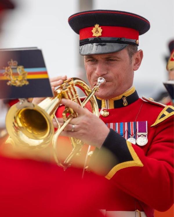 a musician in red uniform