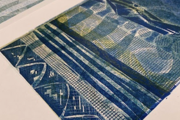 A collograph print of abstract shapes in blues, greens and yellows.