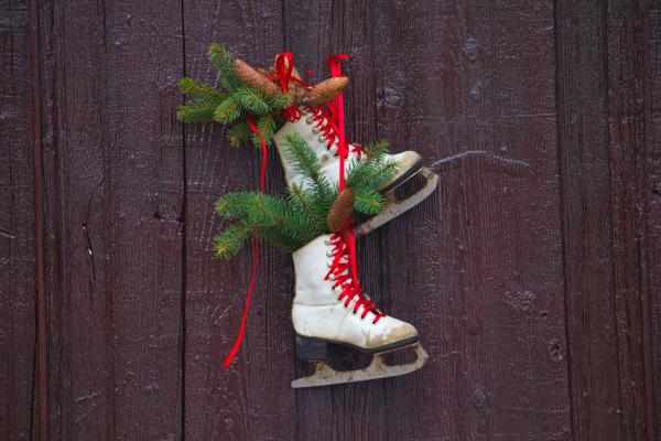 white ice skates with festive foiliage