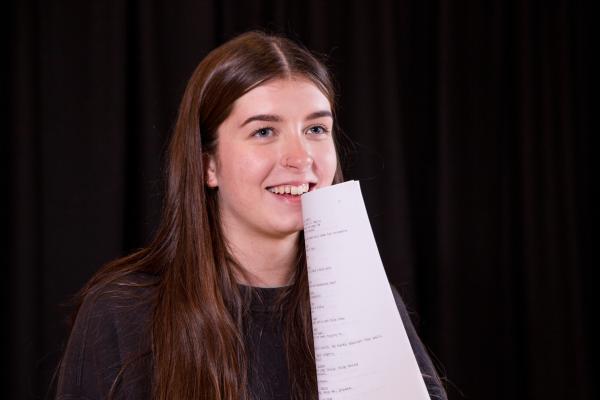 A student holds her script