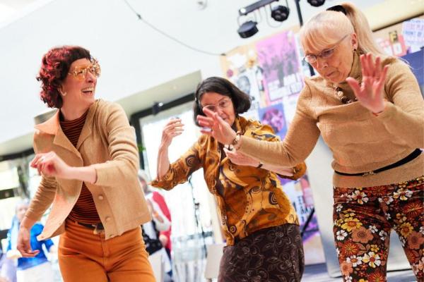 Three older adults dancing