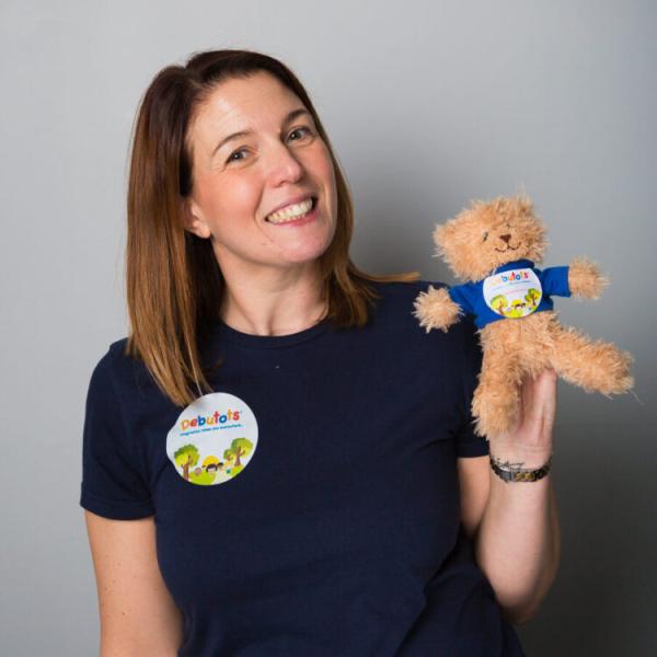 A storyteller holding a teddy bear