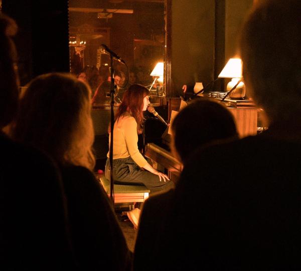 Zoe Cure performing on the in-house upright piano