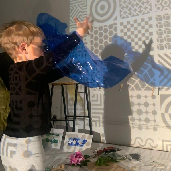 a child playing with gel paper