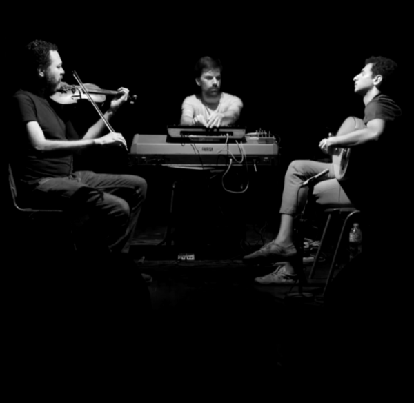 Three men playing music together.