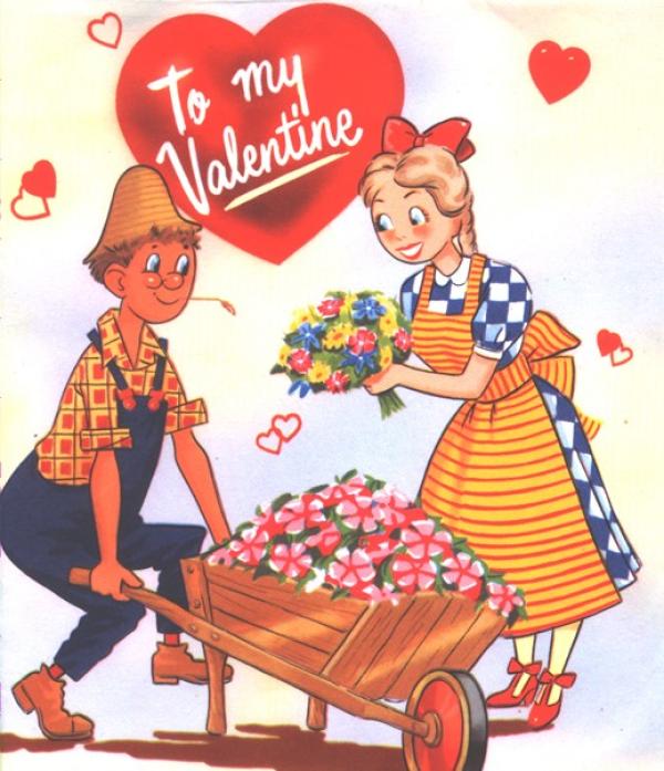 A picture of a Valentine's Day card - boy carting a wooden wheelbarrow filled with flowers. A girl is presenting him with a posey of flowers. A heart above them says 'To my Valentine'