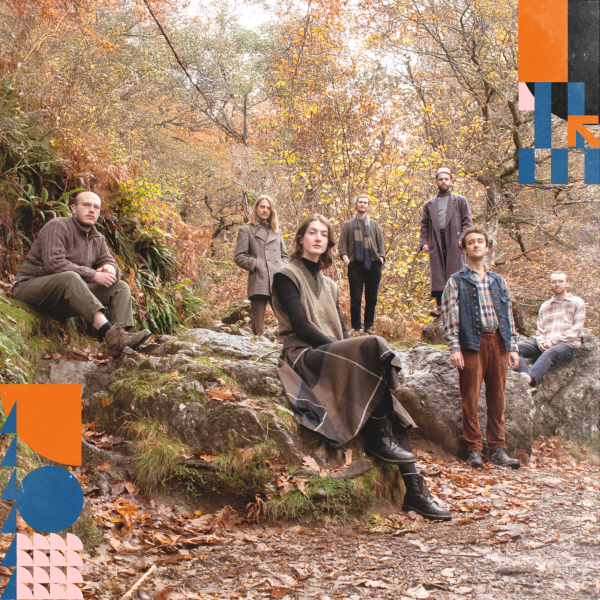 Awen Ensemble group sitting in a forest. 