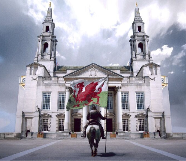 Image of a person riding a horse holding the Welsh flag heading toward the Civic Hall building. 