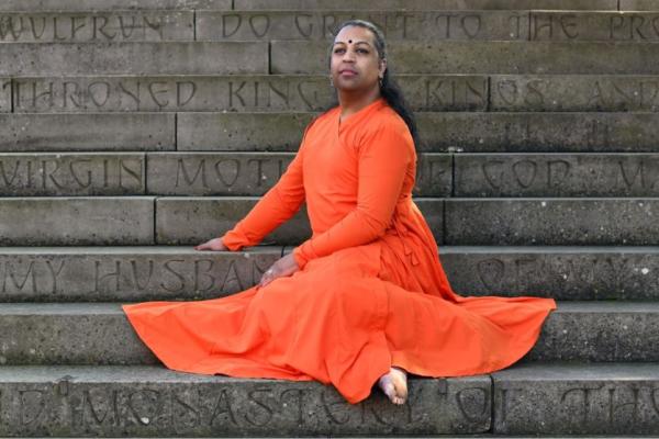 Person in a dress sitting on some steps