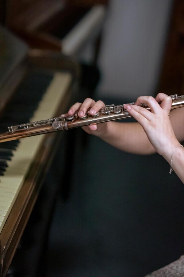 Close up shot of someone playing the flute.