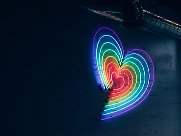 a rainbow heart in neon lighting