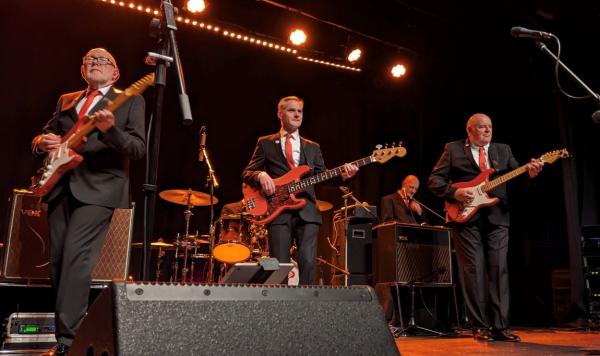 The Bootleg Shadows playing on stage.