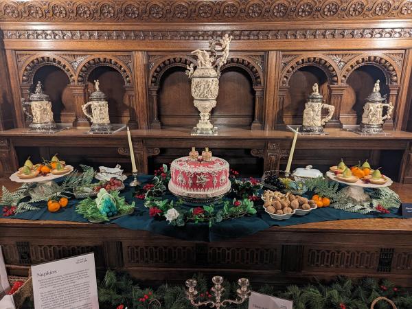 A display showing a feast , including a twelfth night cake