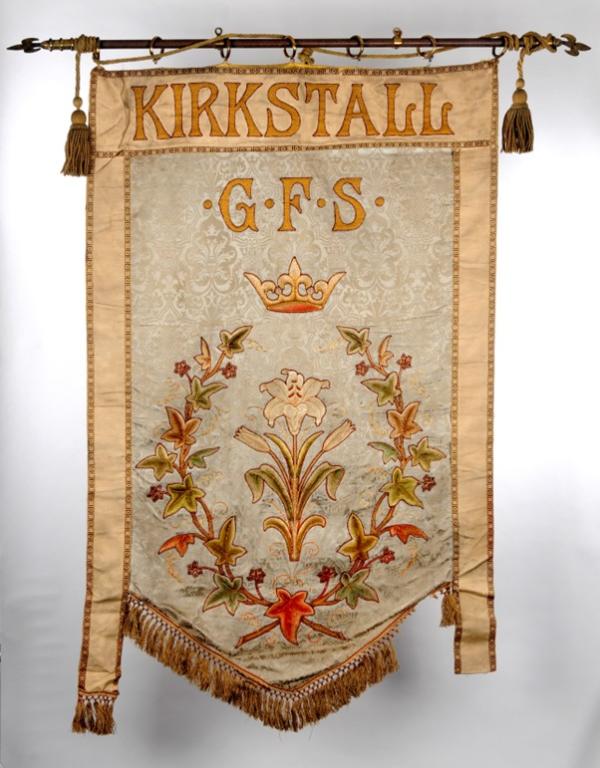 A banner on a pole, with writing, 'Kirkstall G.F.S.', which stands for Girls Friendly Society