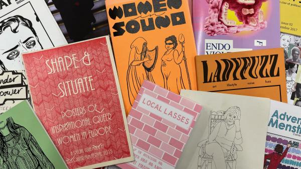 Various zine covers in red, orange, pink and white