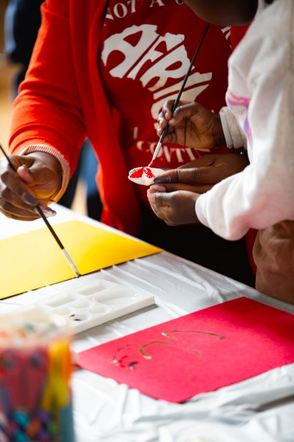 A mother and a child painting.