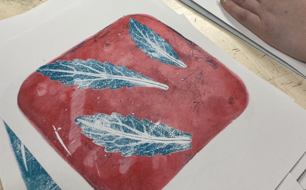 A gelli printed image of leaves in blue and red