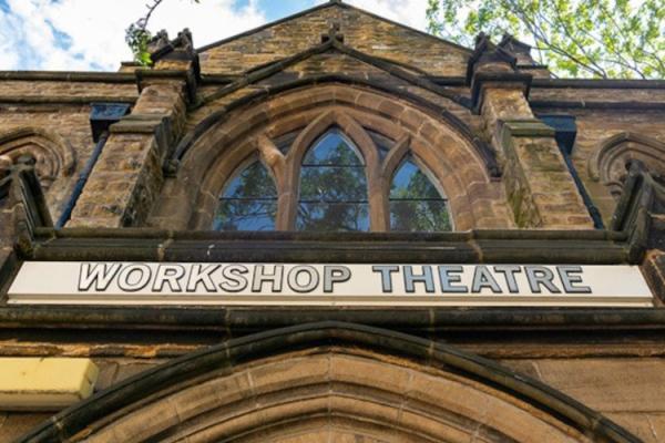 Looking up a a building with sign saying 'workshop theatre'