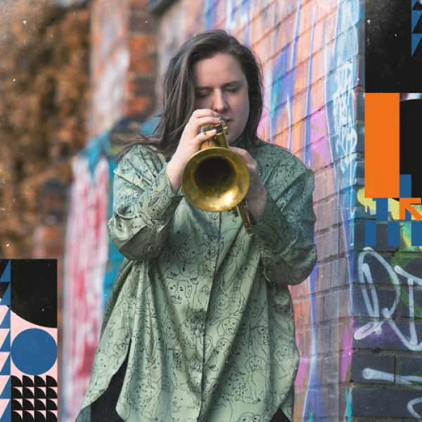 Charlotte Keeffe playing a trumpet next to a wall
