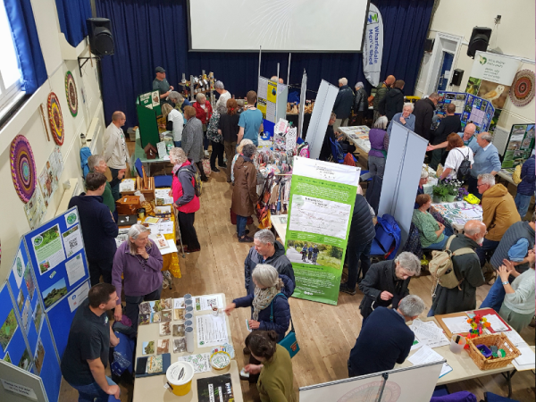 Otley Green Fair stalls in a hall.