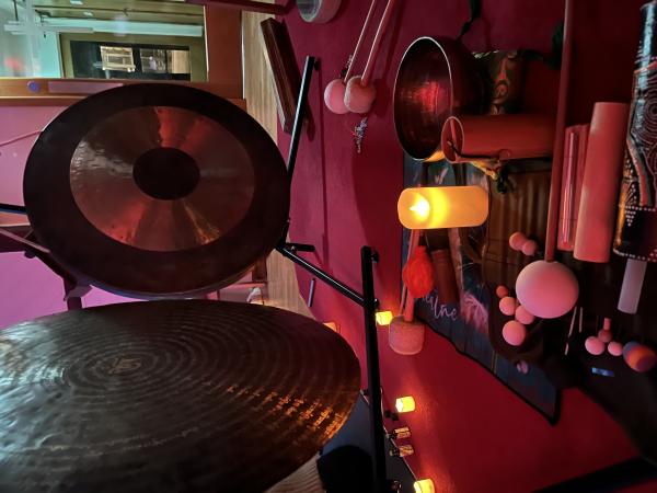A lovely ambient image of backlit musical instruments with gongs, rainsticks and other percussion.