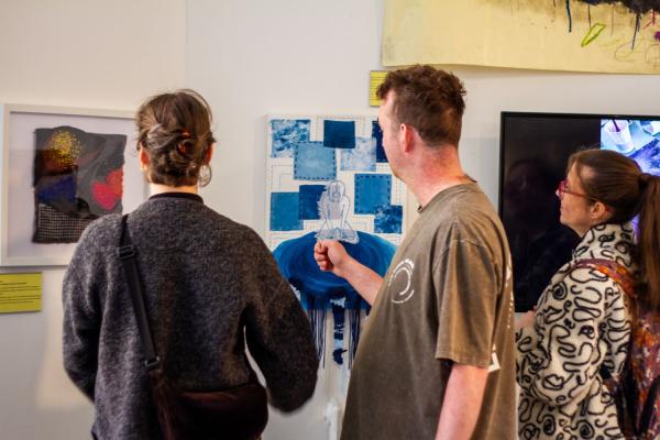 Pyramid artists looking at artwork