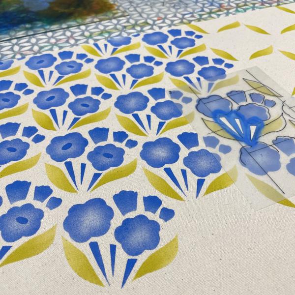 A blue and green floral print lay on a table