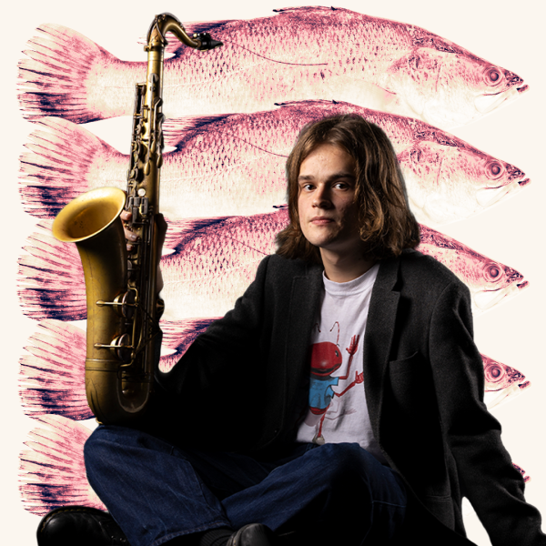 Em Craig sitting cross-legged, holding a saxophone upright. Behind Em, there are 5 pink fish over a beige background.