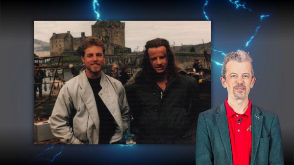Jonathan Ferguson, Keeper of Firearms, in front of photograph of Gregory Wilden and Christopher Lambert on the set of Highlander