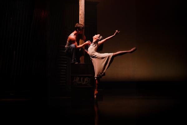 In the glow of a streetlight, two dancers dressed plainly show their love through dance