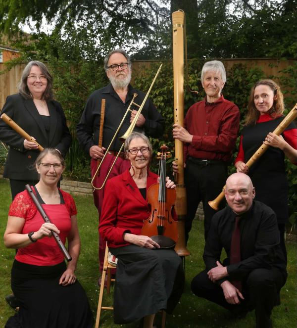 A group of jolly troubadors holdingan array of medieval instruments
