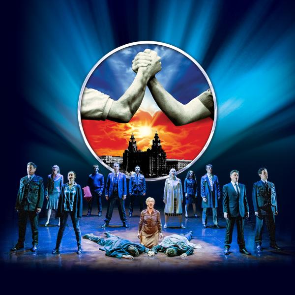 In black and white, against a red and blue sky, two arms clasp hands together. In front of the hands, a group of actors stand in formation on stage, along with two figures lying down.