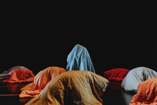 A black dance floor with sleeping bags mountains 