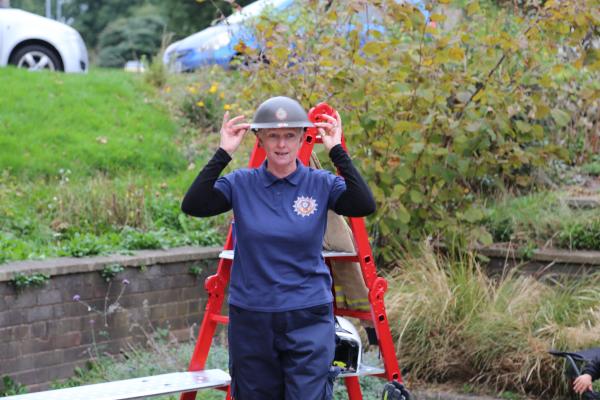 Jane Morland, the performer wearing an vintage metal fire helmet 