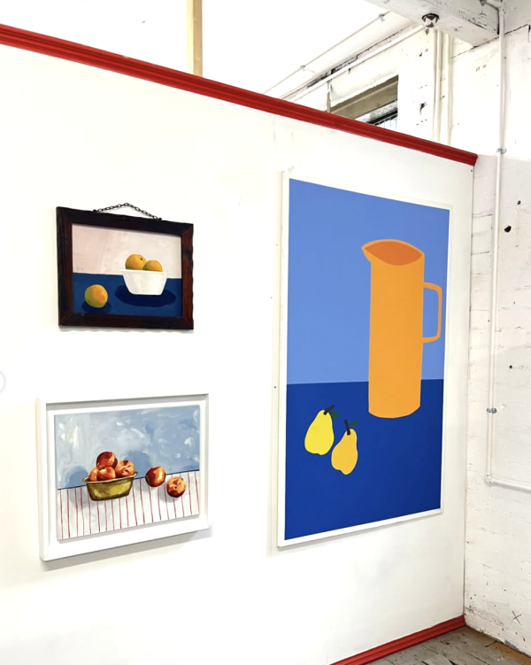 An installation shot of Freya and Joel's work featuring three paintings of still life fruit