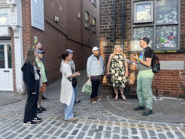 8 people standing in front of Wharf Chambers