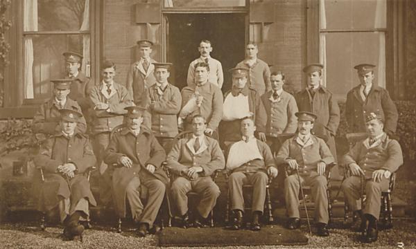 A group of soldiers posing for a group photograph. Some have visible injuries.