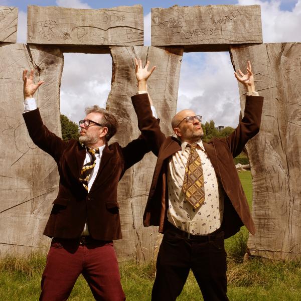 Two hosts pretending to lift stones