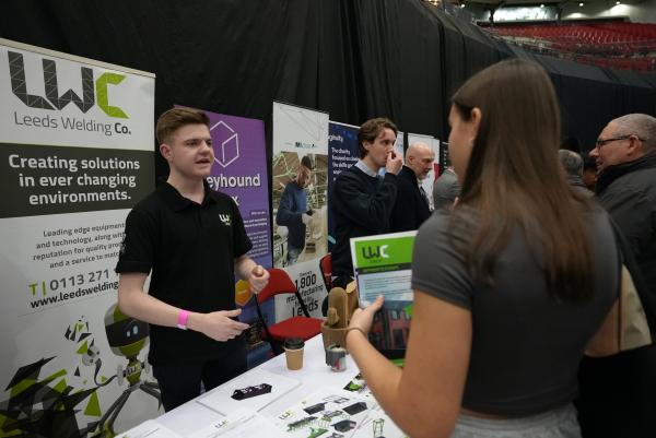A picture of an exhibitor speaking with a visitor at Leeds Apprenticeship Recruitment Fair 2026