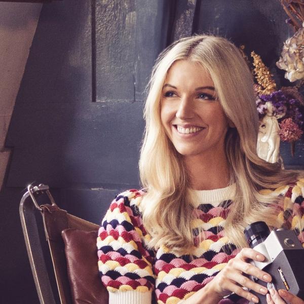 Harriet looking off to the right in a crocheted jumper.