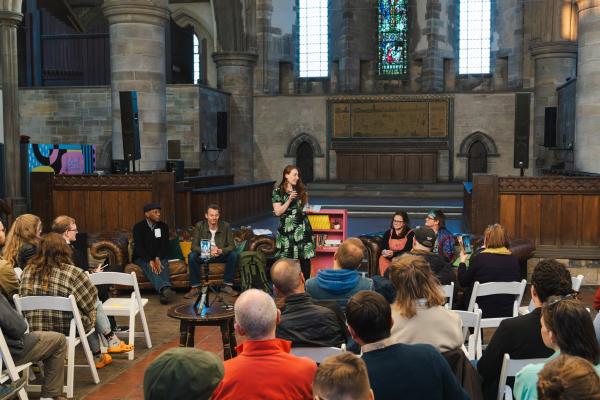 Sarah addressing the audience with the guest panel