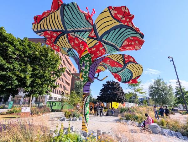 A photo of the "Hibiscus Rising" sculpture on a sunny day.