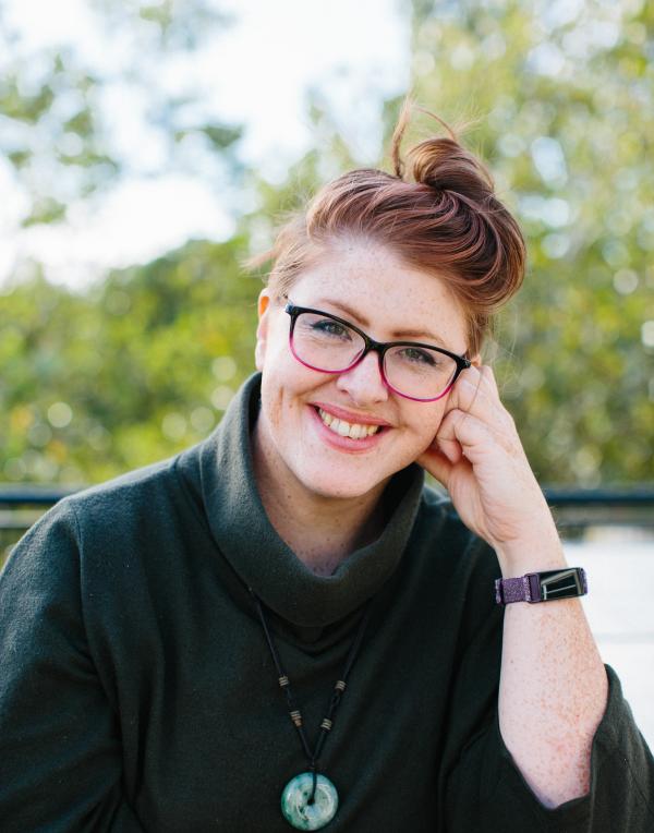 Author headshot in front of nature background