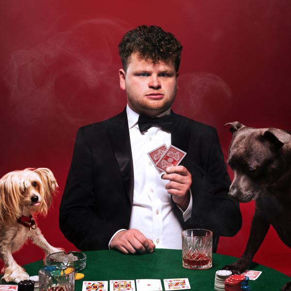 Dan Tiernan playing cards with a couple of dogs! 