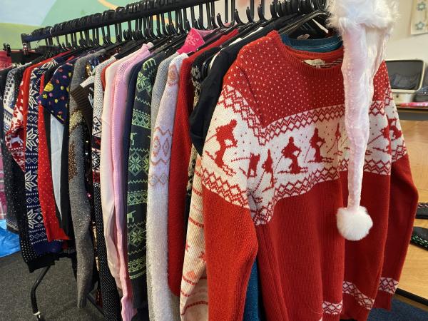 A rail filled with Christmas jumpers