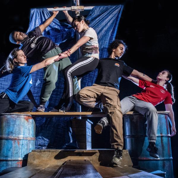 Dancers pose on a raft